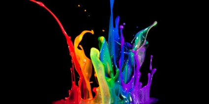 splashes of paint in many colors erupting against a black background