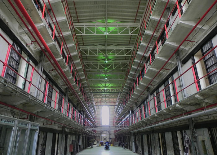 smart decarceration image of prison walkway with cells bars